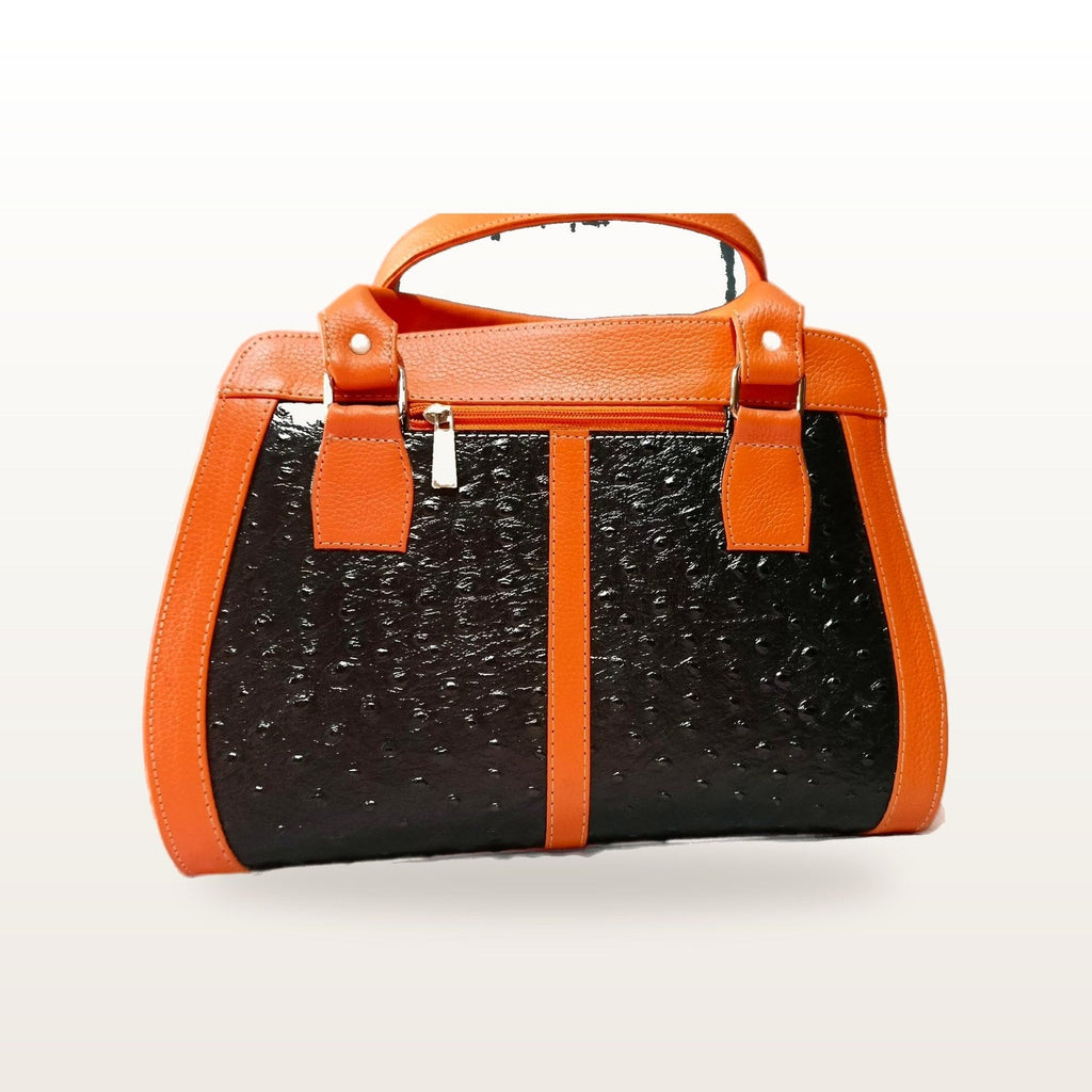 Orange and black leather handbag seen straight on, showing the top zip and handle tabs