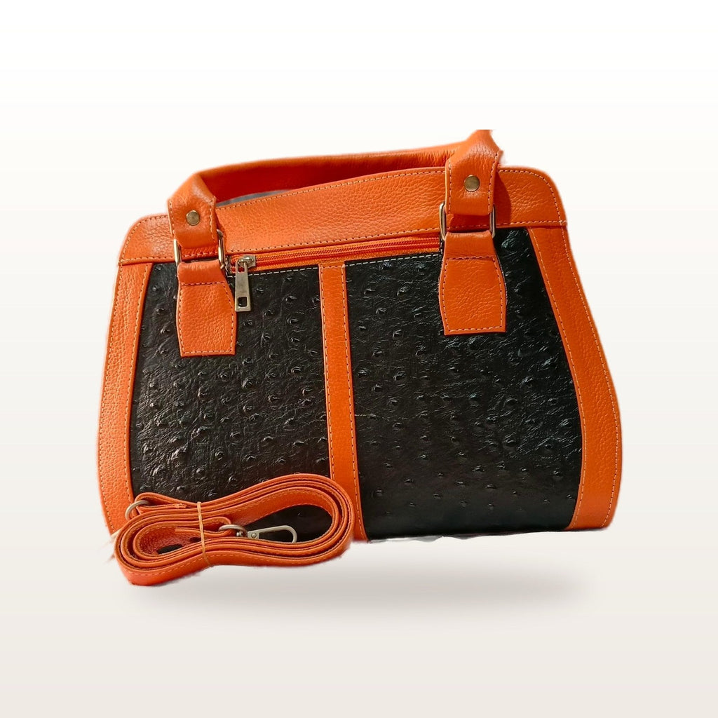 The handbag with its detachable shoulder strap laid in front
