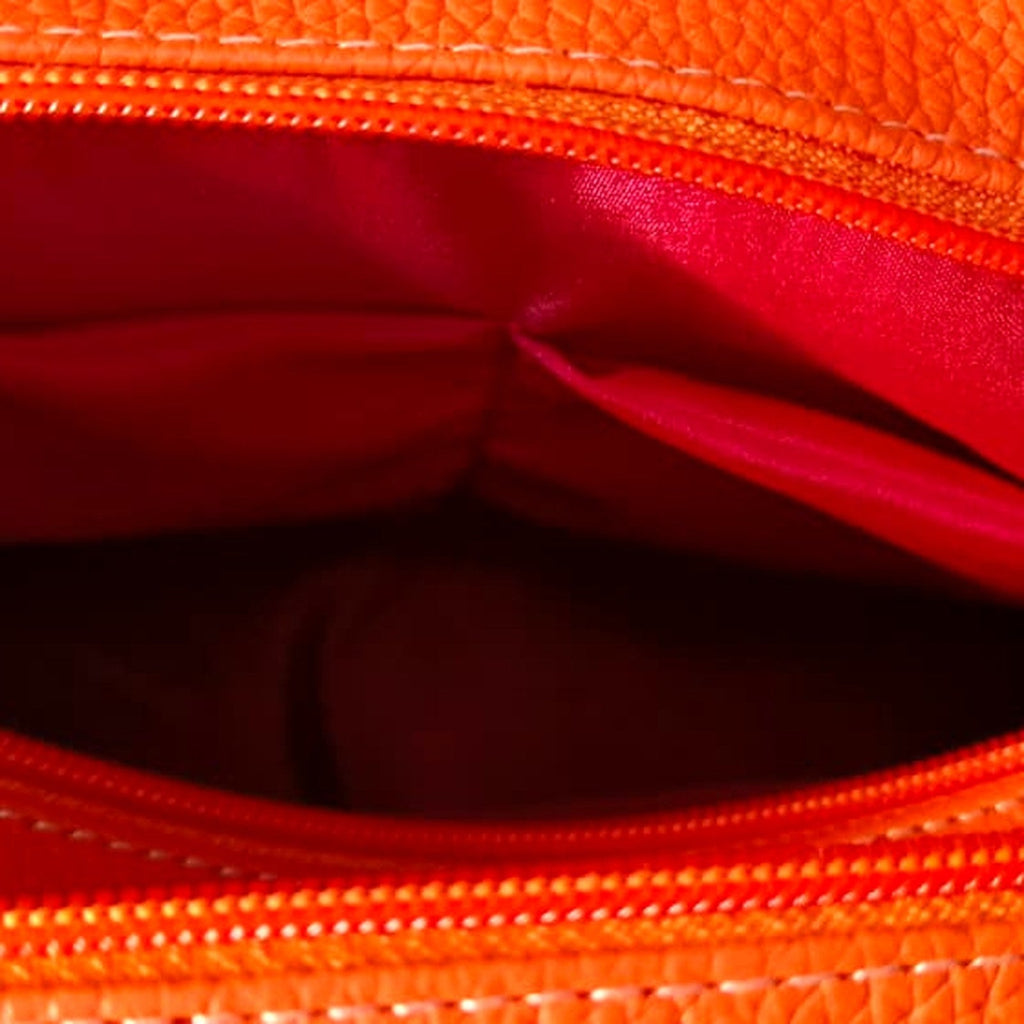 Pink lining inside the handbag, with the inner slip pockets visible