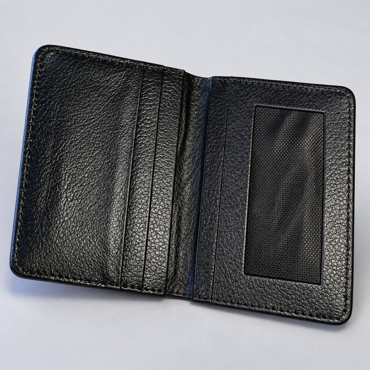 Black leather card holder open, showing three card slots and a clear ID window