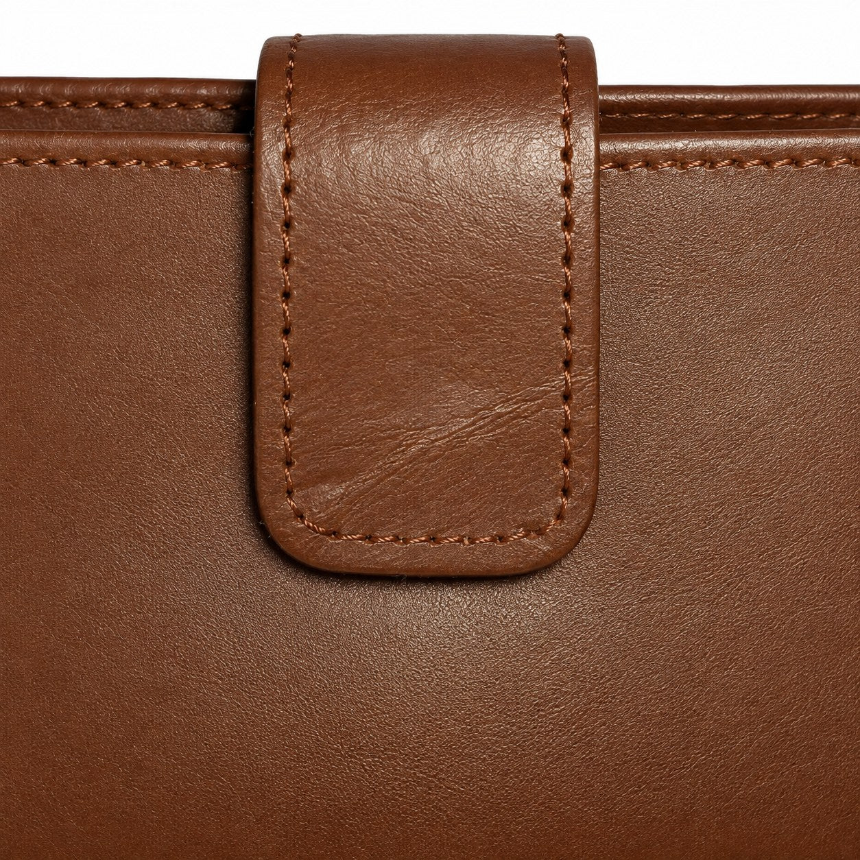 Close-up of the leather closure tab and stitching on the brown long wallet