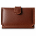 Women's brown leather flap wallet with a snap tab, closed front view