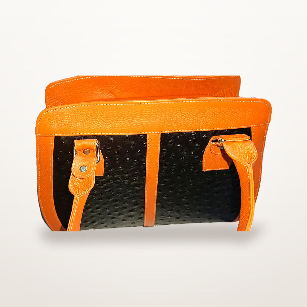 Orange and black leather handbag side angle showing structured shape