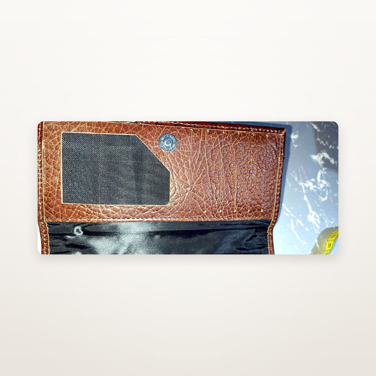 Brown leather long wallet interior showing mesh ID window