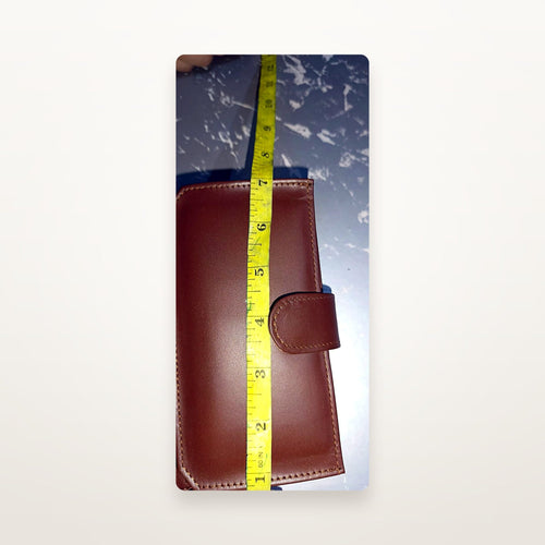 Chestnut leather long wallet with tape measure showing height