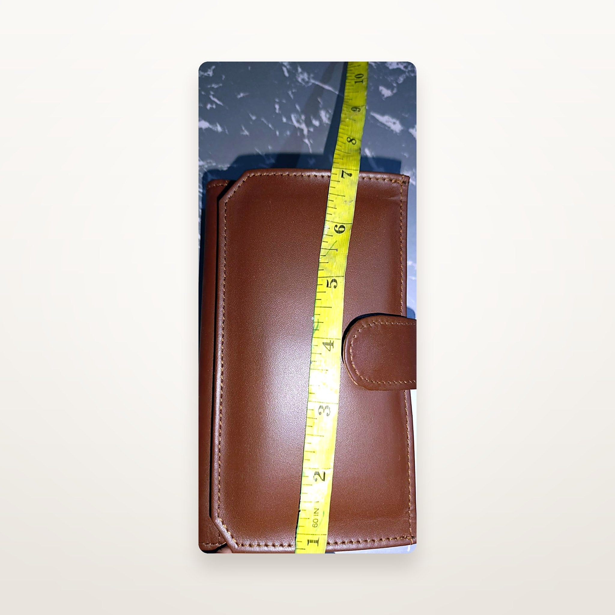 Chestnut leather long wallet size reference with tape measure