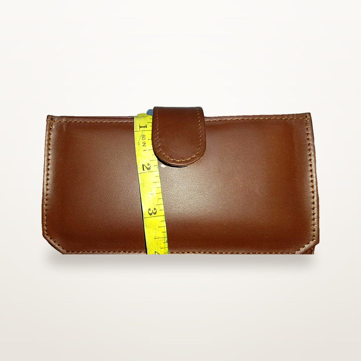 Chestnut leather long wallet closed, showing leather tab and press stud
