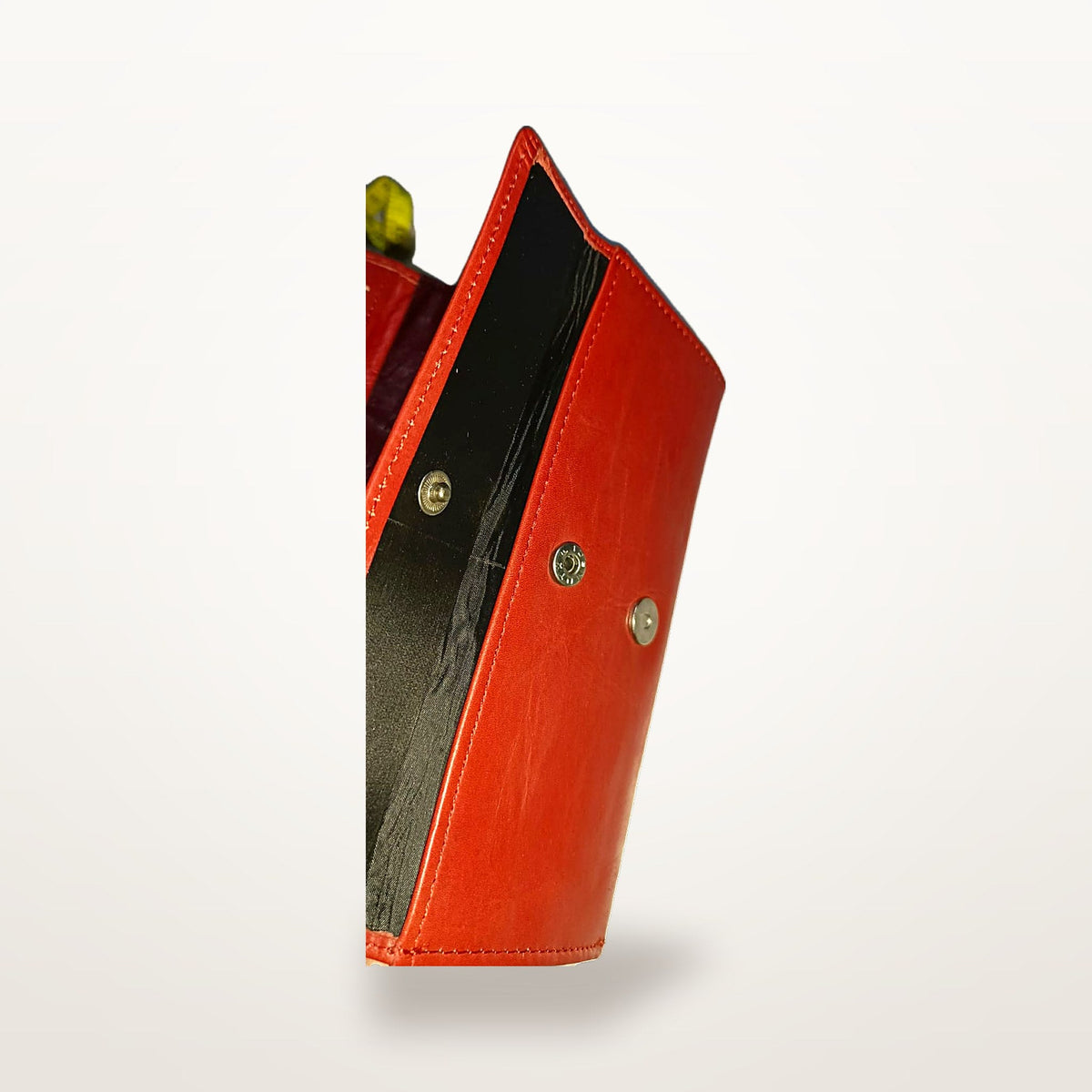 Red leather long wallet with flap open, showing press stud closure